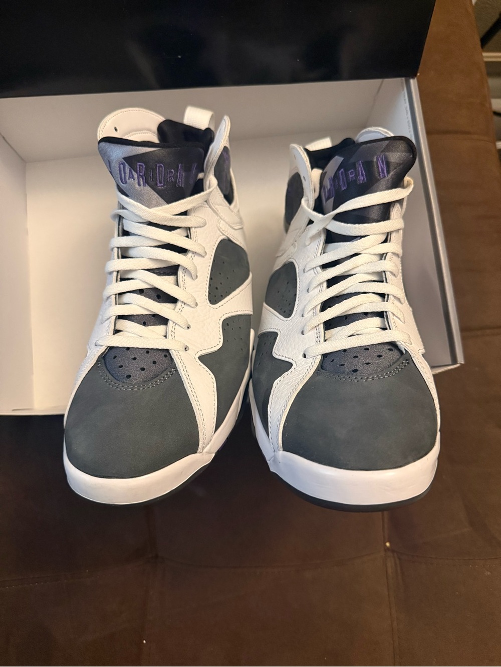 Jordan woman’s Sneakers in White and Gray with Purple Tongue Accents